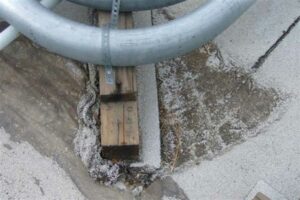 metal pipe on roof supported by wood block